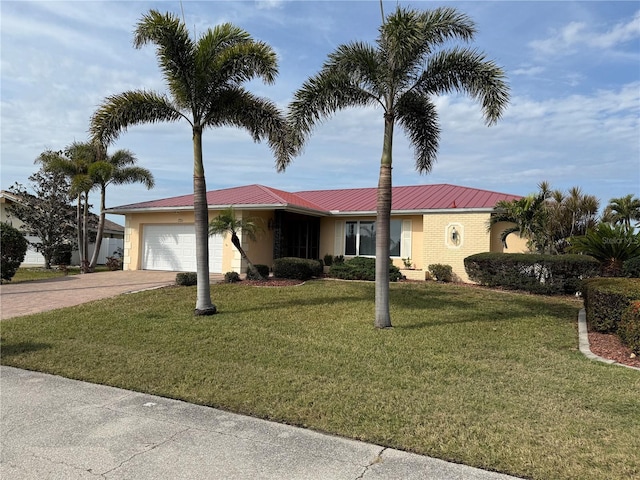 view of front of house with a garage and a front lawn