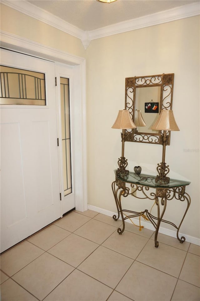 entrance foyer with crown molding and tile patterned flooring