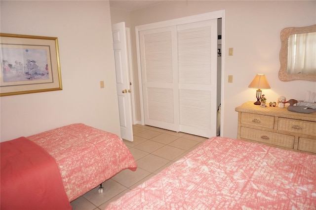 tiled bedroom with a closet