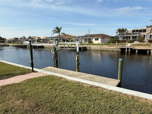 dock area with a water view and a yard