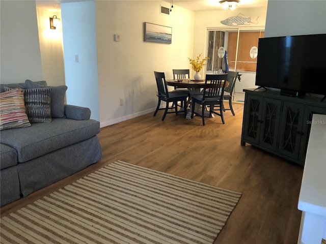 living room with dark hardwood / wood-style flooring