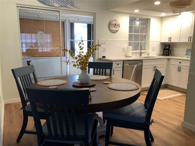 dining area with sink and light hardwood / wood-style flooring