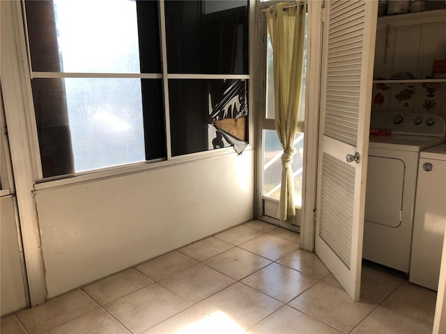 laundry area featuring light tile patterned flooring and washer and dryer