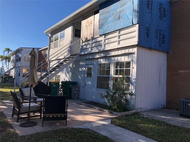 rear view of property with a patio and central AC