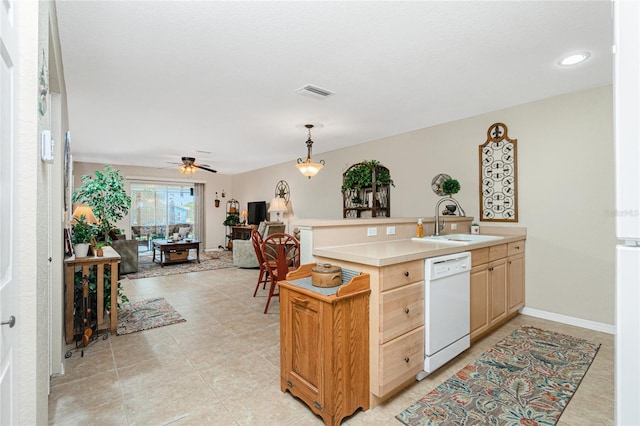 kitchen with pendant lighting, light brown cabinetry, sink, ceiling fan, and white dishwasher