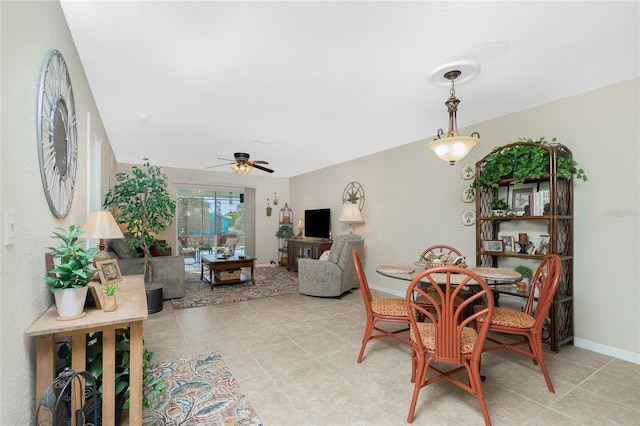 tiled dining area with ceiling fan