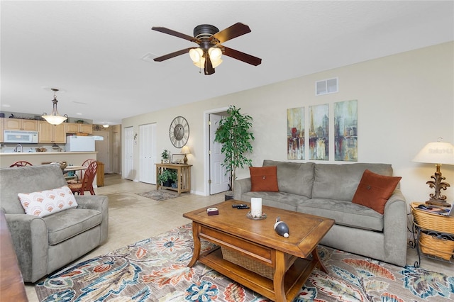 living room with light tile patterned flooring and ceiling fan