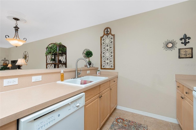 kitchen featuring white dishwasher, sink, hanging light fixtures, and light brown cabinets