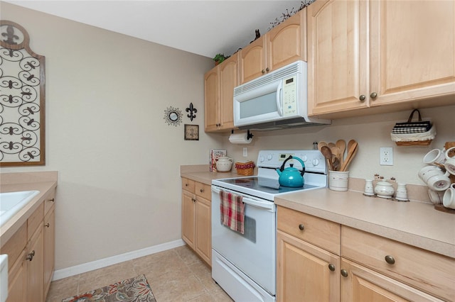 kitchen with white appliances, light brown cabinetry, and light tile patterned floors