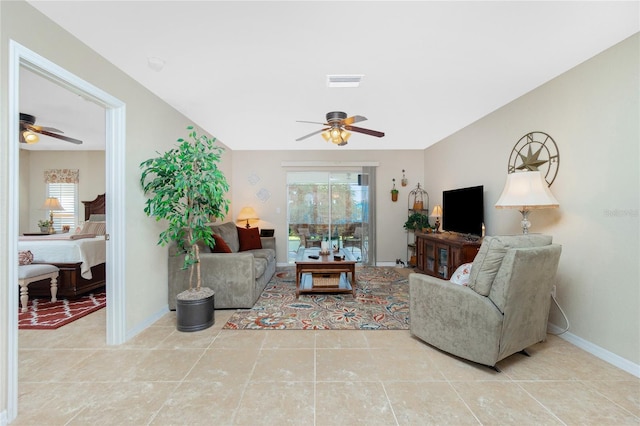 living room with light tile patterned floors and ceiling fan