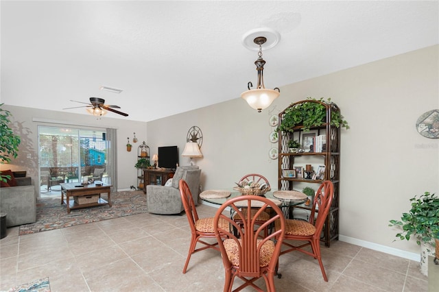 tiled dining room featuring ceiling fan