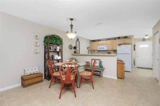 dining space featuring light tile patterned flooring