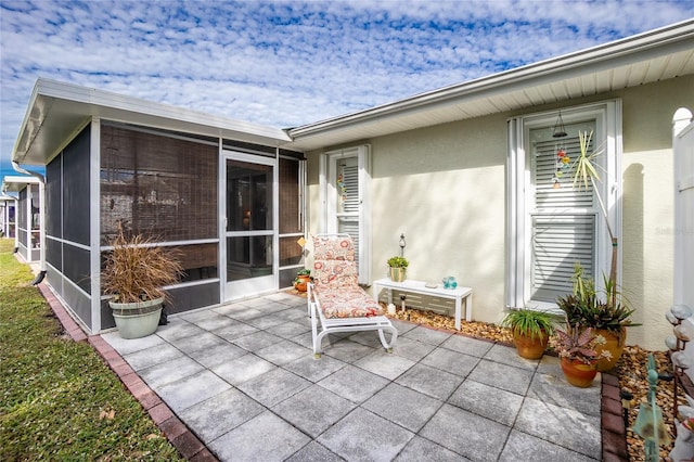 view of patio with a sunroom