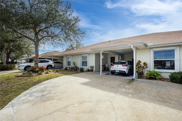 view of front of house with a front lawn and a carport