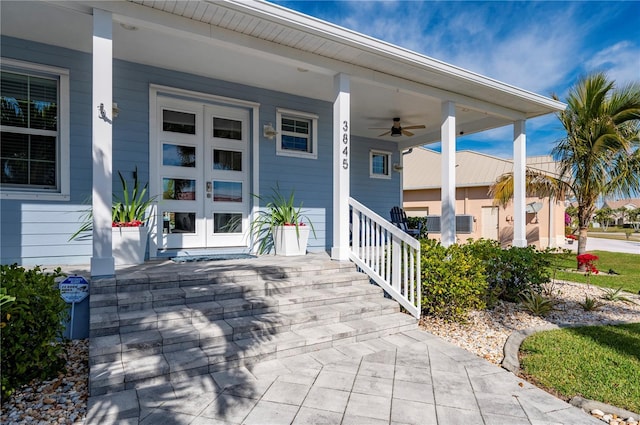 doorway to property featuring ceiling fan and a porch