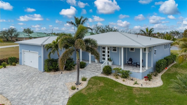 ranch-style house with a porch, a garage, and a front yard