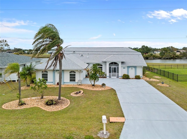 view of front facade featuring a front yard and a water view