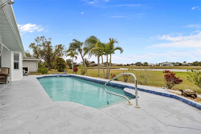 view of swimming pool featuring a yard and a patio area