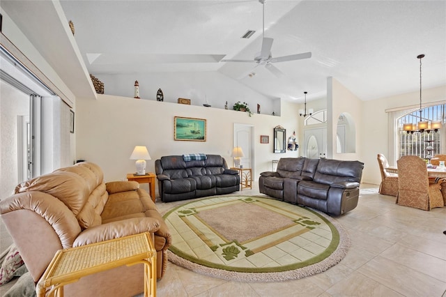 tiled living room featuring vaulted ceiling and ceiling fan with notable chandelier