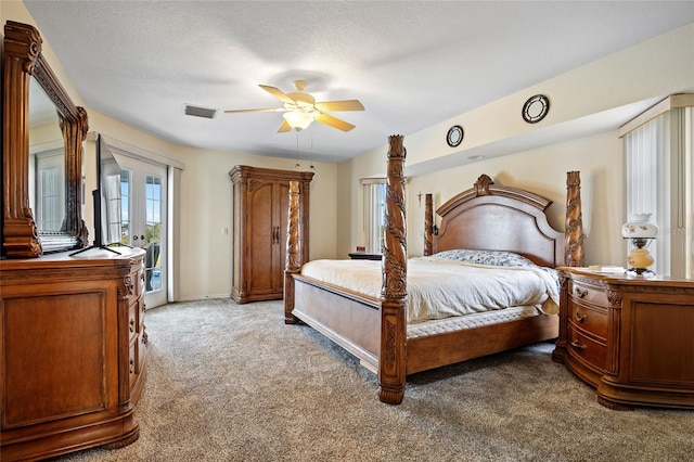 carpeted bedroom with access to outside, a textured ceiling, and ceiling fan