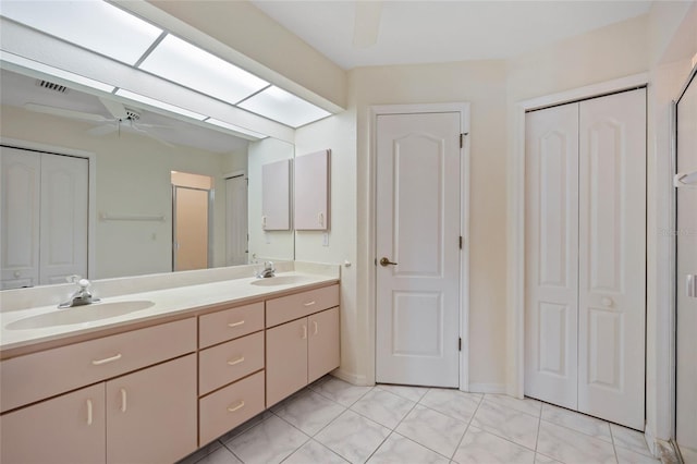 bathroom with vanity, tile patterned flooring, a skylight, and ceiling fan