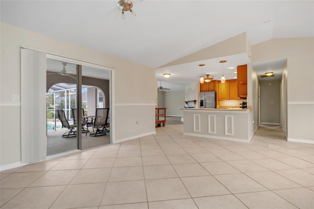 unfurnished living room featuring vaulted ceiling, light tile patterned floors, and ceiling fan