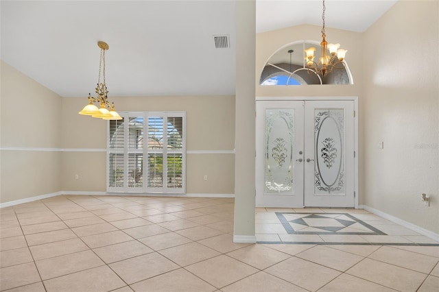 foyer featuring light tile patterned flooring, lofted ceiling, a notable chandelier, and french doors