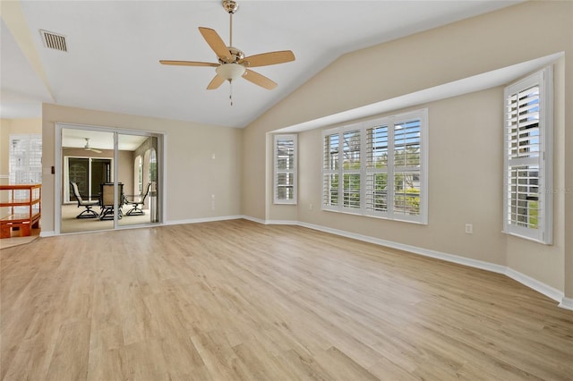 unfurnished living room with ceiling fan, lofted ceiling, and light wood-type flooring