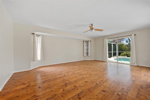 unfurnished room with ceiling fan and light wood-type flooring