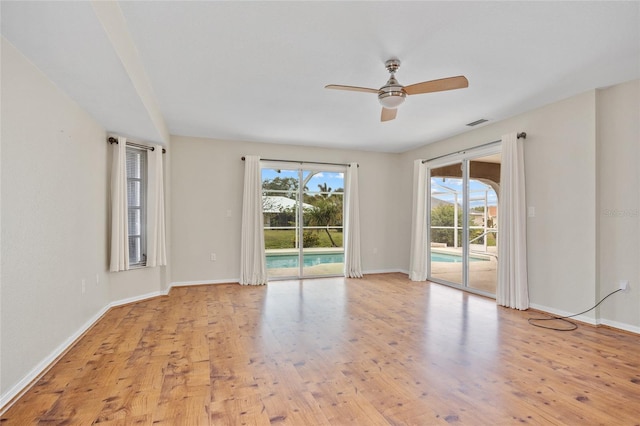 unfurnished room with ceiling fan and light wood-type flooring