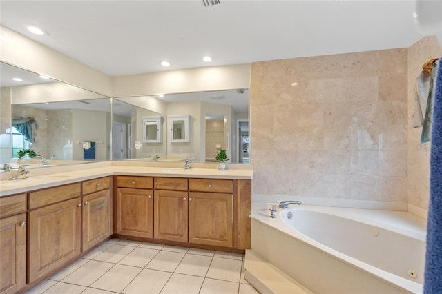 bathroom featuring vanity, a bath, tile patterned flooring, and tile walls