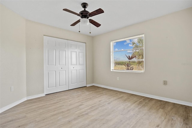 unfurnished bedroom featuring light hardwood / wood-style floors, a closet, and ceiling fan