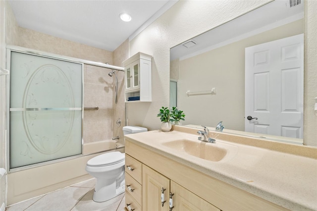 full bathroom featuring tile patterned flooring, vanity, shower / bath combination with glass door, and toilet