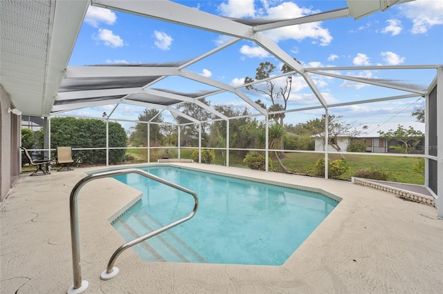 view of swimming pool featuring a lanai, a lawn, and a patio area