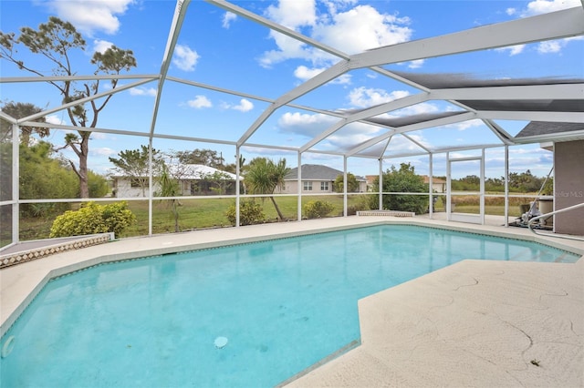 view of swimming pool with a lanai and a patio area