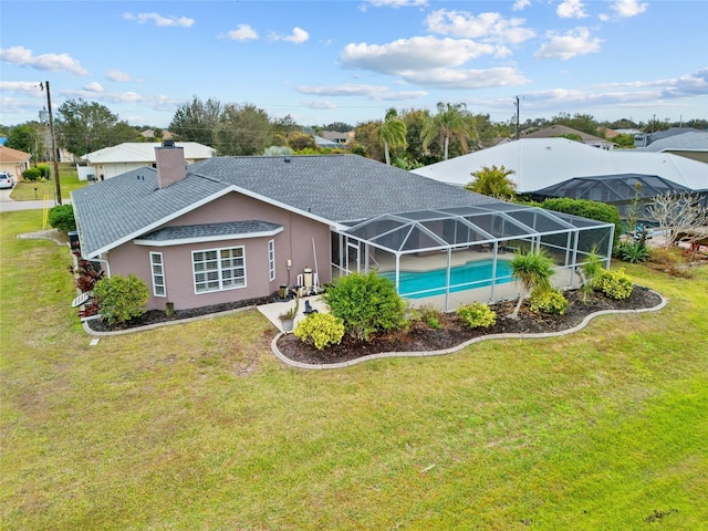 back of house featuring a yard and a lanai