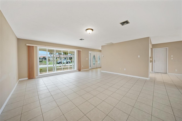 unfurnished room with light tile patterned flooring