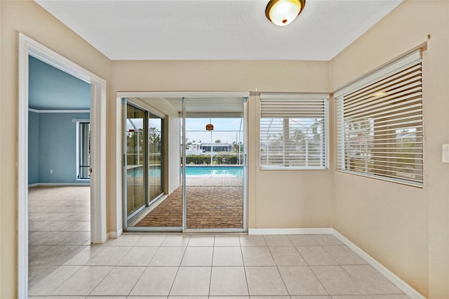 doorway to outside with light tile patterned floors