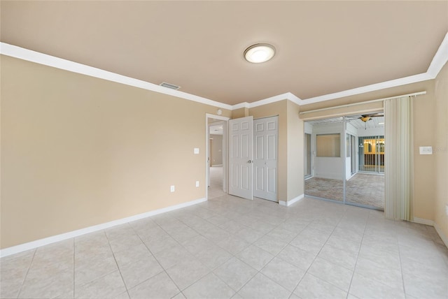 tiled spare room with ornamental molding