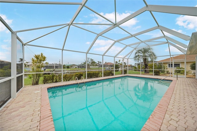 view of pool with a patio and a lanai