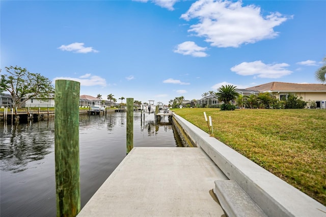 view of dock featuring a yard and a water view