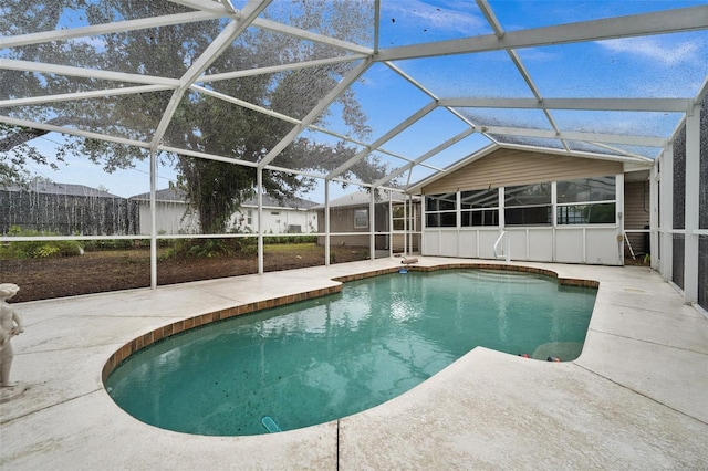 view of pool with a patio and glass enclosure