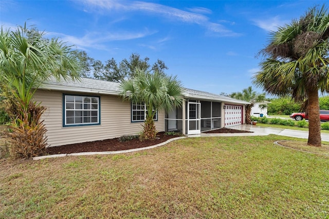 view of front of property featuring a garage, a sunroom, and a front yard