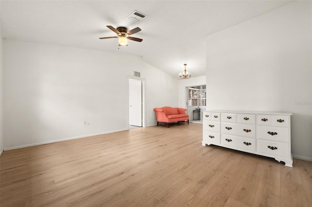 unfurnished room with ceiling fan with notable chandelier, lofted ceiling, and light wood-type flooring