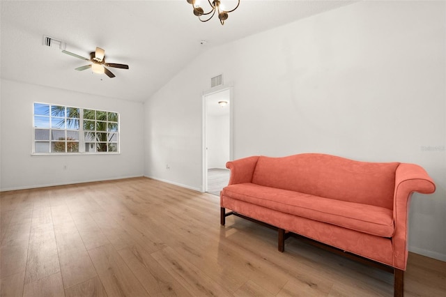 living area with light wood-type flooring, vaulted ceiling, and ceiling fan