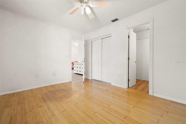 unfurnished bedroom featuring a closet, ceiling fan, and light hardwood / wood-style flooring