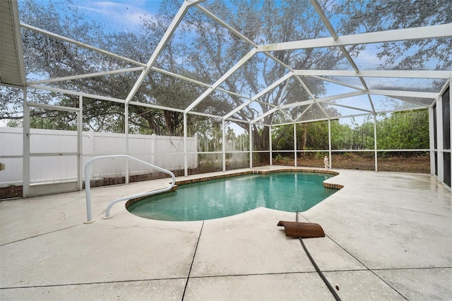 view of pool featuring glass enclosure and a patio