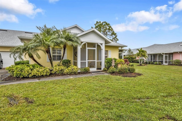 view of front of home featuring a sunroom and a front yard