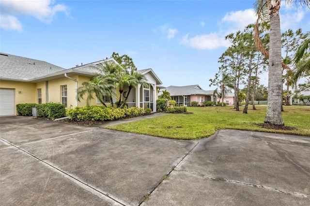 view of front of property with a garage and a front yard