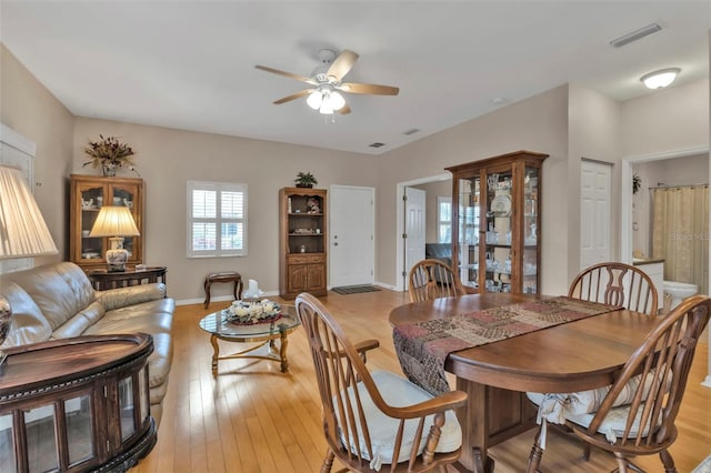 dining area featuring ceiling fan and light wood-type flooring